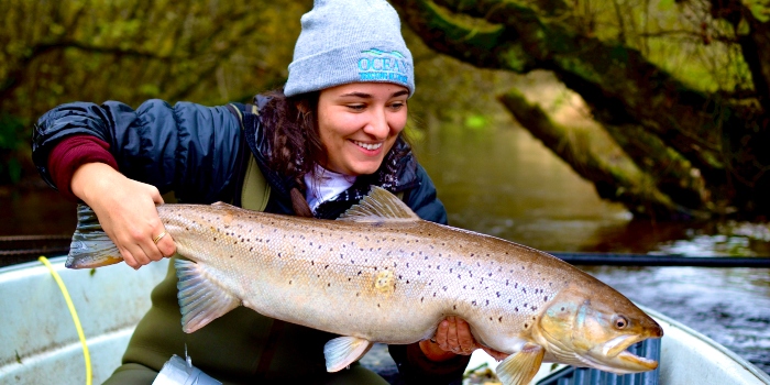 Kim Birnie-Gauvin with an 83 cm large sea trout—ready to be released in Villestrup Å stream after being tagged. Photo Jessica Desforges
